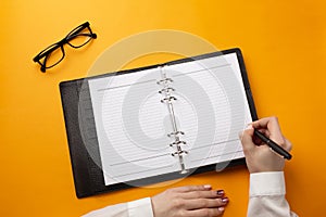 Professional doctor writing medical records in a notebook