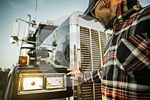 Professional Driver Checking On His Semi Truck Headlights