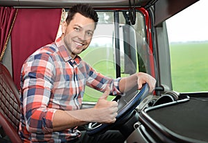 Professional driver sitting in cab of truck