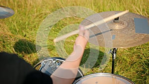 Professional drummer, playing the drum set and cymbals, on street, close-up