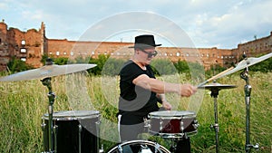 Professional drummer, playing the drum set and cymbals, on street, close-up