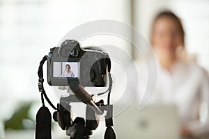 Professional dslr digital camera filming vlog of business woman