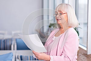 Professional elderly woman reading a document