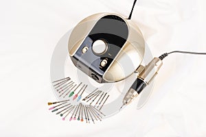 Professional electric nail drill manicure and pedicure machine and set of diamond cutters on white background
