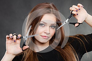 Professional elegant female barber with scissors.