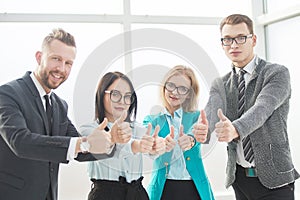Professional employees of the company showing thumbs up.