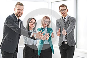 Professional employees of the company showing thumbs up.