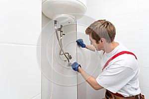 Professional engineer doing a boiler inspection at home