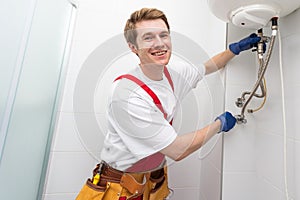 Professional engineer doing a boiler inspection at home