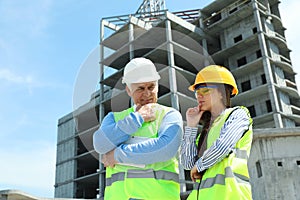 Professional engineer and foreman with tablet in safety equipment