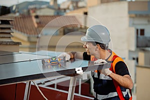 Professional engineer measuring solar panels on the roof of a house