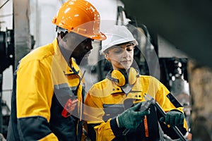 professional engineer team checking product quality control in metal workshop production line photo