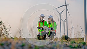 Professional engineer technician working outdoor at wind turbine field