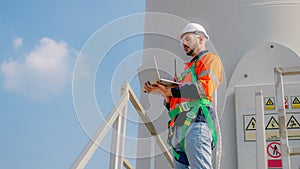 Professional engineer technician working outdoor at wind turbine field