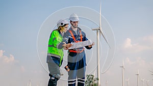 Professional engineer technician working outdoor at wind turbine field