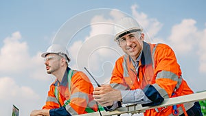 Professional engineer technician working outdoor at wind turbine field