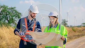 Professional engineer technician working outdoor at wind turbine field