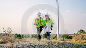 Professional engineer technician working outdoor at wind turbine field