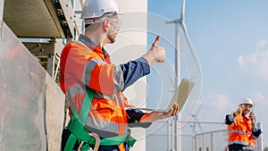 Professional engineer technician working outdoor at wind turbine field