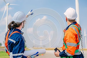 Professional engineer technician working outdoor at wind turbine field