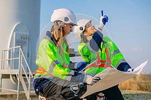 Professional engineer technician working outdoor at wind turbine field