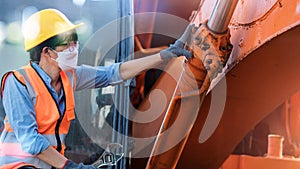 .Professional engineer women work of mechanical. Checking and repair maintenance excavators machine in construction site on sunset