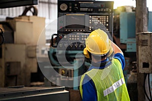 Professional engineers in factory. Technicians are showing machine control and checking the operation of machines in industrial