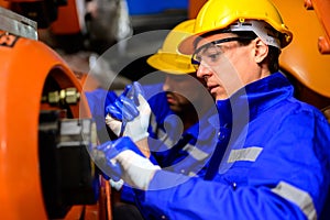 Professional engineers technicians working at industrial factory