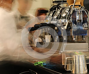 professional espresso machine in the bar  with silhouettes of baristas due to the use of a long exposure technique