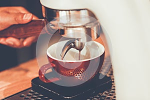 Professional espresso machine brewing a coffee.