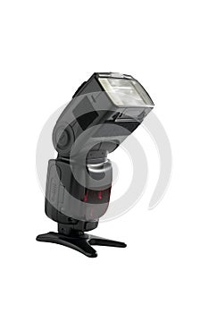A professional, expensive external remote photography digital travel flash standing on a table tripod, cut out on white background