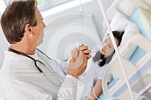 Professional experienced doctor treating his patient