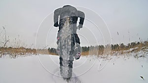 Professional extreme sportsman biker riding fat bike in outdoor. Close-up view of rear wheel. Cyclist ride in winter