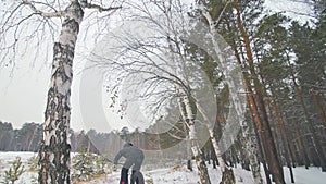 Professional extreme sportsman biker riding fat bike in outdoor. Cyclist ride in winter snow forest. Man does trial