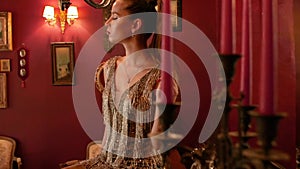 Professional fashion model with a tail poses for a photographer indoors in vintage style. fashion industry, beauty, backstage