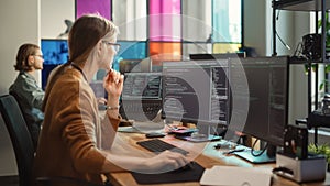Professional Female Backend Software Developer Coding on Desktop Computer With Two Displays in