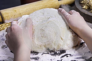 Professional female baker cooking dough. Baking background with dough, flour and rolling pin