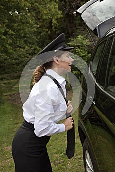 Professional female car driver adjusting her tie