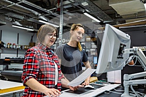 Professional female employees working in a printing house