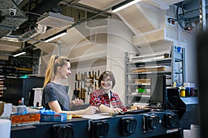 Professional female employees working in a printing house