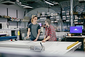 Professional female employees working in a printing house