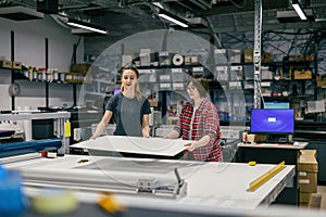 Professional female employees working in a printing house