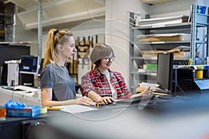 Professional female employees working in a printing house