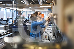 Professional female employees working in a printing house