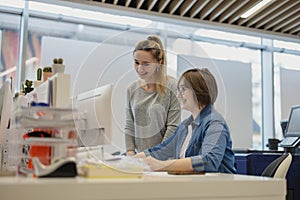 Professional female employees working in a printing house