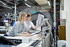 Professional female employees working in a printing house