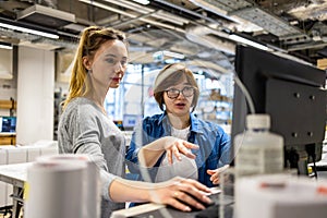 Professional female employees working in a printing house