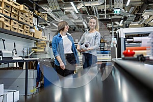 Professional female employees working in a printing house