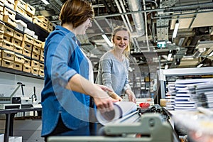 Professional female employees working in a printing house