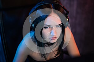 Professional Female Gamer Plays in MMORPG Strategy or Shooter Video Game on His Computer. She`s Participating in Online